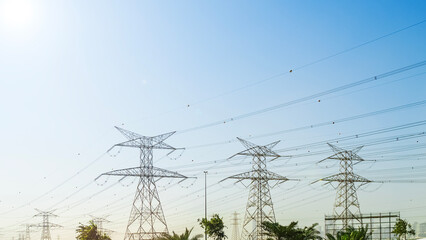 High voltage power lines in Dubai. Voltage electricity pylons in the desert.