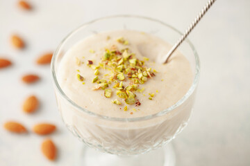 Traditional delicious Turkish Dessert Keskul with nuts in cream bowl