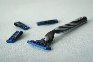 razor blade on light background. manual face shaving machine. stubble blade. depilation