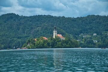 Panoramic view of Lake Bled, Church and lush green forest around the beautiful lake in Slovenia