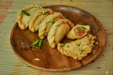 Fried pastel, a savory and crunchy snack made from flour with chicken filling. 
