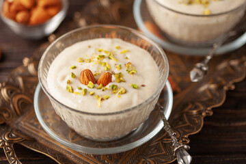 Traditional delicious Turkish Dessert Keskul with nuts in cream bowl