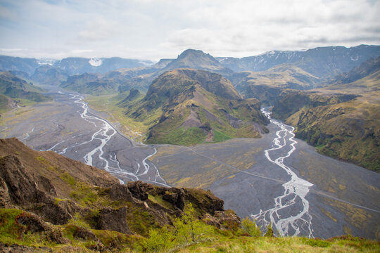 Rivers meandering through the Thorsmork valley in South Iceland during Summer amidst panoramic backdrop of mountains and glaciers