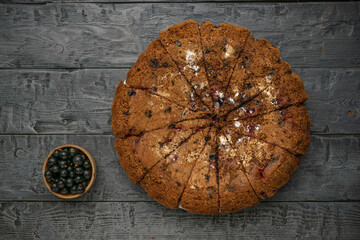 Rustic Blueberry Pie on Wooden Table with Bowl of Fresh Blueberries
