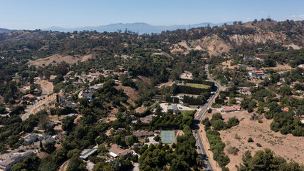 Fototapeta premium Afternoon aerial view of the sprawling neighborhood houses and hills of La Habra Heights, California, USA.