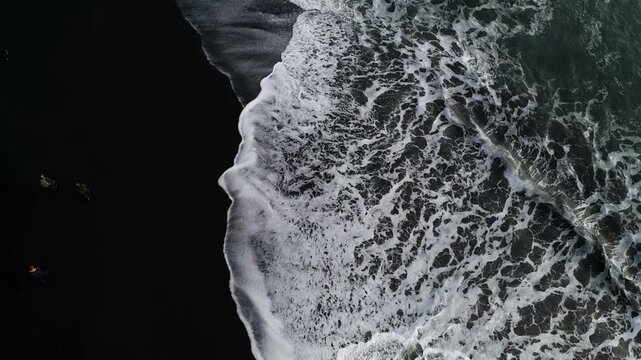 Aerial top view of wave of Black Sand Beach Reynisfjara in Iceland.