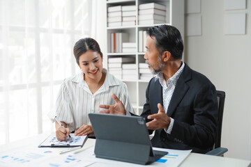 Modern office meeting, business team using digital tablet to discuss work