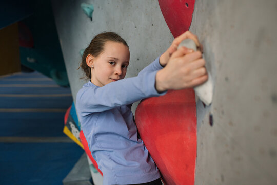 portrait of a girl climbing at an indoor climbing centre