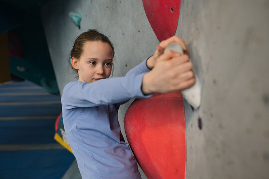 portrait of a girl climbing at an indoor climbing centre