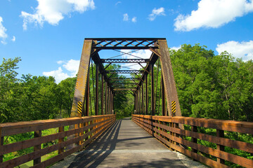 Sunny Summer day landscape of a bike trail passing over an old trestle along the Root River and Harmony-Preston Valley Trails near Preston, Minnesota. © Dave
