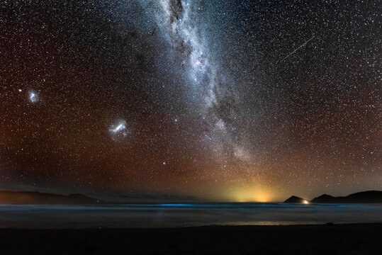 Magellanic Clouds and Milky Way galaxies over bioluminescence