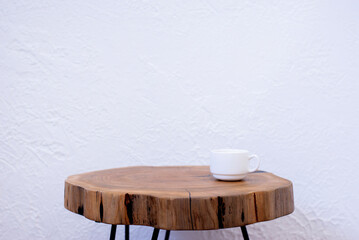 A cup of coffee on the table. Wooden table in loft style with epoxy resin. A table made of cross-cut wood.