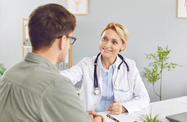 Doctor or nurse provides a medical consultation and support to a patient in a clinic office. This healthcare visit emphasizes the professional care and assistance available in a hospital setting.