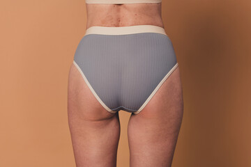No filter photo of elderly woman body shape imperfections birthmarks stretch marks isolated on...