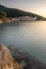 Beautiful historical skyline of a village on the Mediterranean, taken in the morning at sunrise on the beach and sea. Dream harbor landscape in Mošćenička Draga, Moscenicka Draga, Istria, Croatia