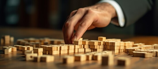 Naklejka premium Businessman hands with wooden domino effect concept for business