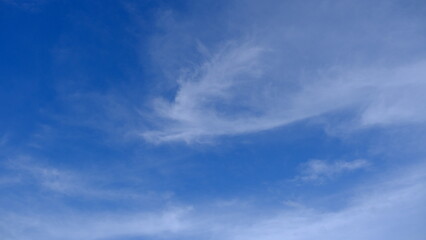 A clear blue sky adorned with soft, wispy clouds, creating a serene and calming landscape perfect for relaxation and inspiration.