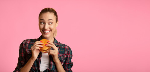 Cheat Meal. Pretty Lady Eating Hamburger Over Yellow Studio Background. Free Space