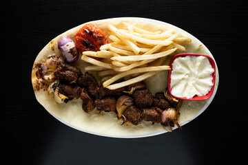 bbq Lamb Tikka Meat kabab with french fries and mayo dip served in dish isolated dark background top view of indian spices, bangladeshi and pakistani food