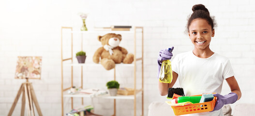 Cheerful black girl with detergents variety ready to clean home, helping parents, copy space