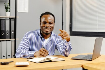 Fototapeta premium Man working at desk with laptop