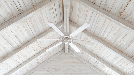 A bright and airy ceiling with whitewashed wooden planks and a large central fan