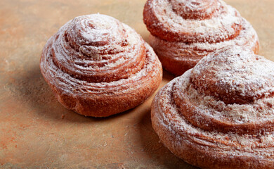 bakery product, lemon twist, with white glaze, sweet bun, muffin, pastries, top view, no people,