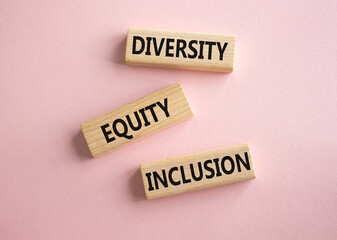 Diversity Equity Inclusion symbol. Concept words Diversity Equity Inclusion on wooden blocks. Beautiful pink background. Business and Diversity Equity Inclusion concept. Copy space