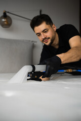 Mattress cleaning with extractor at home. Dry cleaning with extractor to get rid of stains, dust and dirt on house furniture.