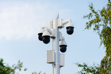 Security systems and alarm technology concept: Many CCTV cameras hanging on an outdoor pole and recording. Digital surveillance. High safety and protection cam and video.