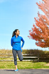Asian woman, legs and stretching with earphones for music, workout or outdoor training in...