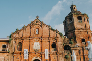 Fototapeta premium Historic Baroque Brick Church with Bell Tower in the Philippines (Saint John the Baptist Parish Church, Liliw, Laguna)