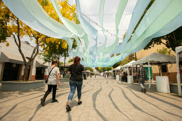 Zapopan, Jalisco, Mexico - June 7, 2024: Morning sun shines on people walking along the plaza of Arcos de Zapopan. © Matt Gush