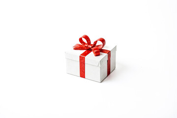 Fototapeta premium White Gift Box with Red Ribbon on White Background