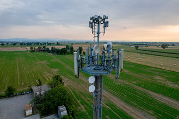 Telecommunication tower dominating rural landscape at sunset