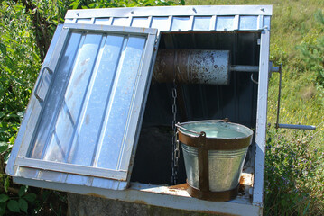A well and a bucket of fresh spring water.