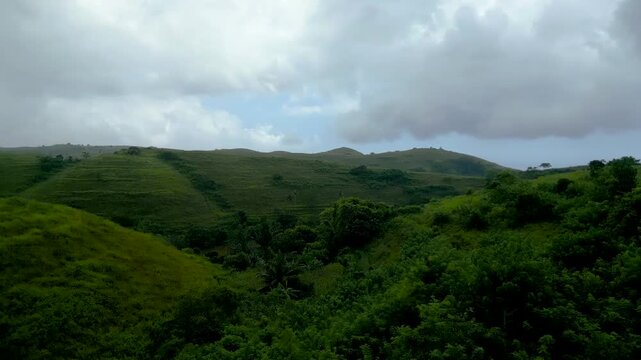 Aerial, Teletubbies Hills of Nusa Penida Island Used by Locals as Farming Terraces. Abundant farmland rolling hills and a tourist Attraction in Bali - Indonesia