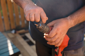 Person Holding Drill Outside on Sunny Day
