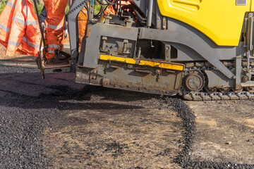 Asphalt Paver Machine Laying Fresh Asphalt on Road