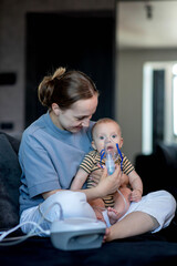 Woman putting on a mask up a nebulizer mask to her child's face