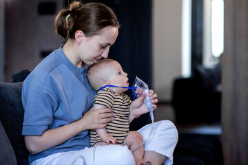 Woman putting on a mask up a nebulizer mask to her child's face