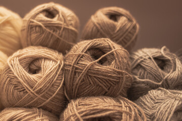 Obraz premium Several skeins of colored yarn. Fluffy plush yarn in cozy colors. Crocheting and knitting. A calm and safe hobby. Yarn texture close-up. Handicraft store. A wound thread. Color gradient. Matte image. 