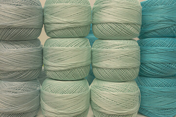 Several skeins of colored yarn. Fluffy plush yarn in cozy colors. Crocheting and knitting. A calm and safe hobby. Yarn texture close-up. Handicraft store. A wound thread. Color gradient. Matte image. 