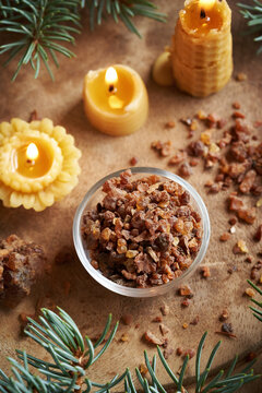 A bowl of myrrh resin with bees wax candles