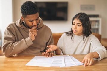 Couple Reviewing Documents at Kitchen Table During Daytime