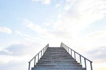 Concrete Stairs Leading Upwards Against a Cloudy Sky