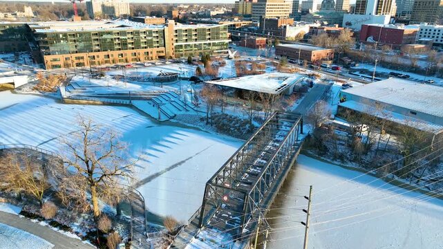 Aerial Tracking Shot of Snowy Promenade Park and MLK Bridge in Fort Wayne