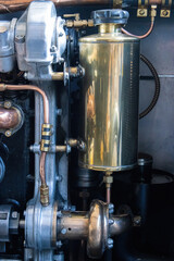 detail of old car engines made from different coloured metals