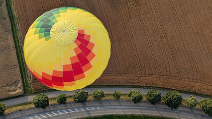 hot air ballon flying above a field