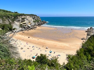 sandy beach between cliffs